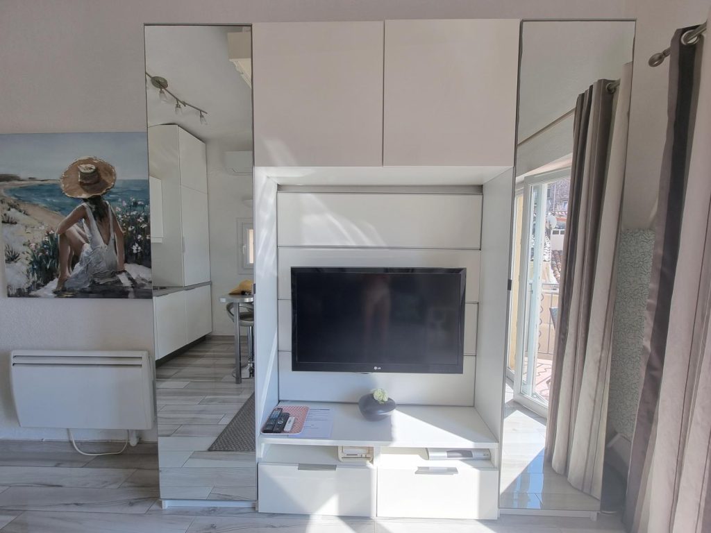 Two tall mirrored wardrobes