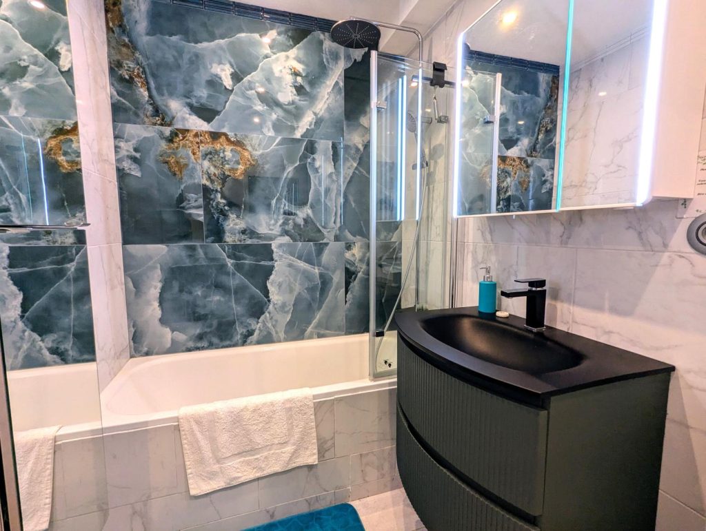 Bathroom with bath and attached shower head