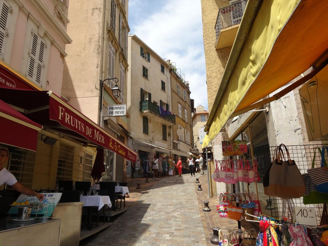 A narrow pedestrian street climbing through Le Suquet in Cannes