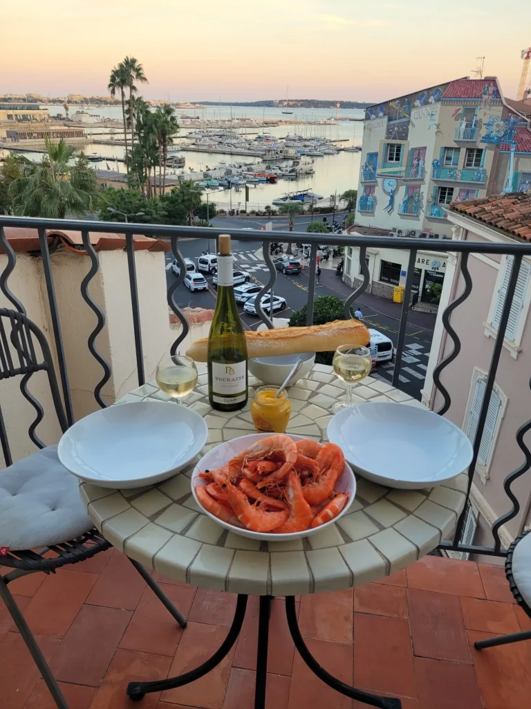 Seafood supper on the Studio de le Port balcony overlooking Cannes Old Port at sunset